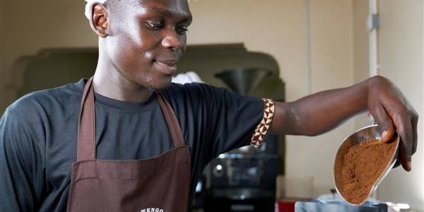 Kimco Coffee, a man packaging ground coffee